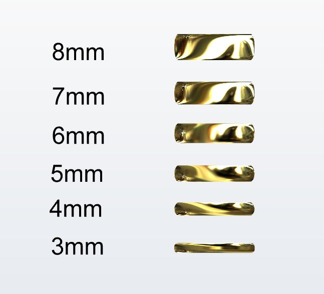 Set of gold D-shaped rings with varying widths on a white background
