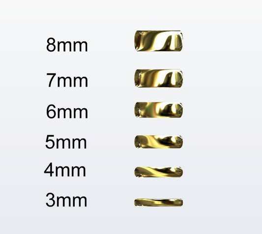 Set of gold D-shaped rings with varying widths on a white background