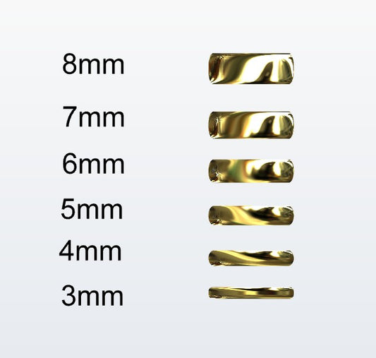 Set of gold D-shaped rings with varying widths on a white background