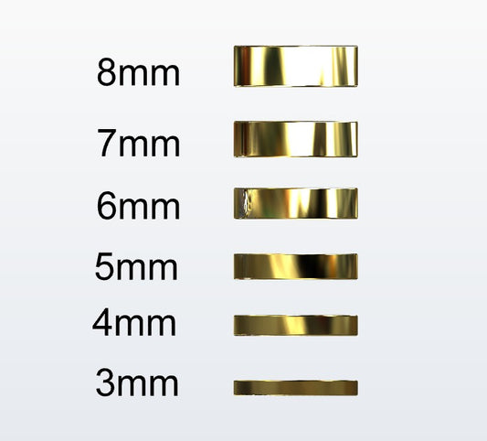 Set of gold flat profile rings with varying widths on a white background