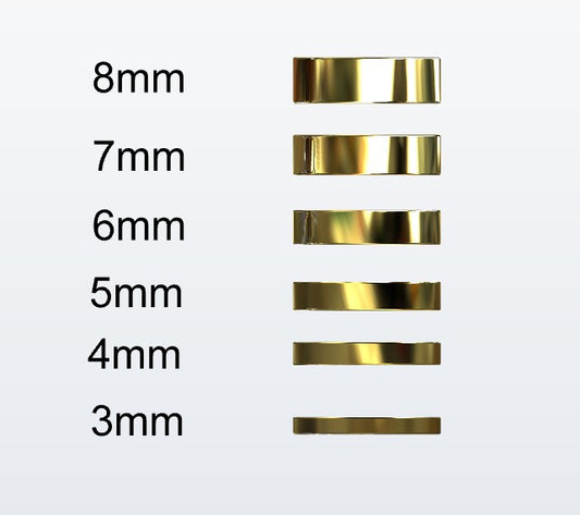 Set of gold flat profile rings with varying widths on a white background