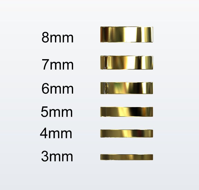 Set of gold flat profile rings with varying widths on a white background
