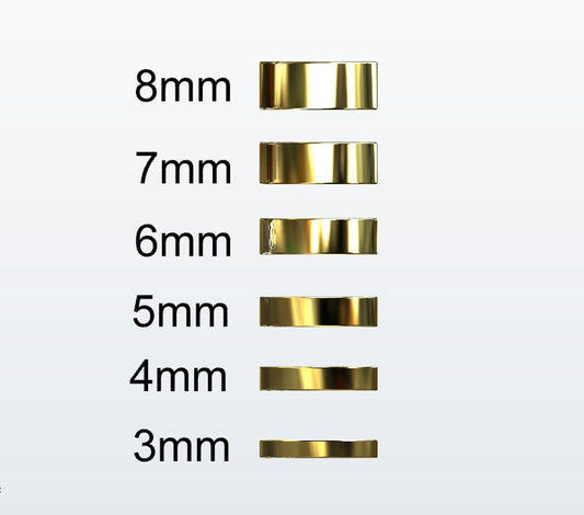 Set of gold flat profile rings with varying widths on a white background