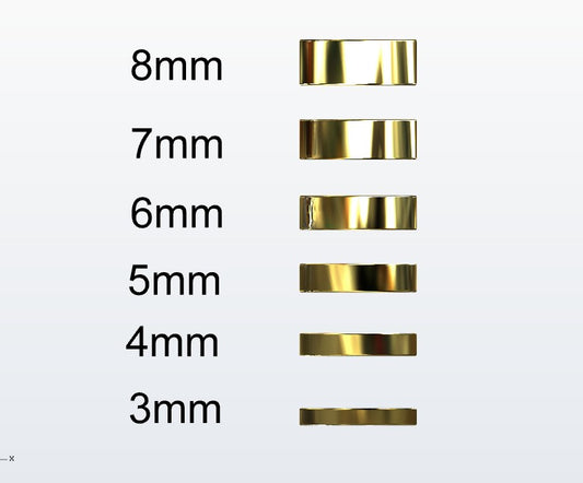 Set of gold flat profile rings with varying widths on a white background