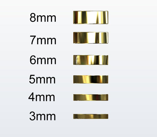 Set of gold flat profile rings with varying widths on a white background