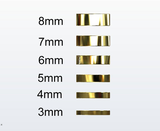 Set of gold flat profile rings with varying widths on a white background