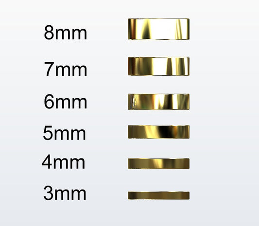 Set of gold flat profile rings with varying widths on a white background
